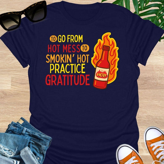 Flaming hot sauce bottle beside the text “Hot Mess to Smokin’ Hot, Practice Gratitude” on a navy unisex tee.