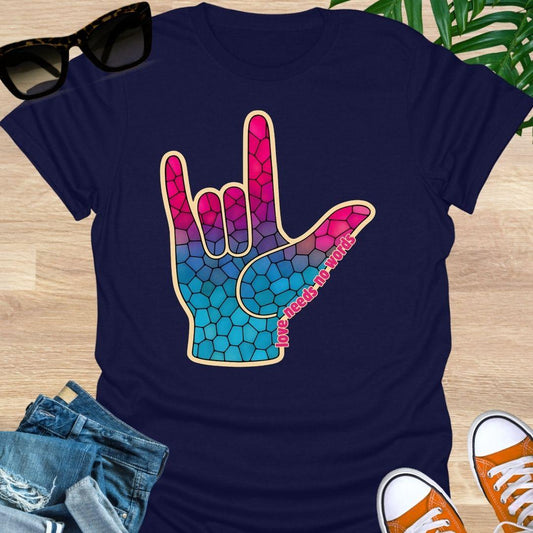 ASL I Love You hand in pink-to-blue mosaic with the words “love needs no words” on a navy unisex tee.