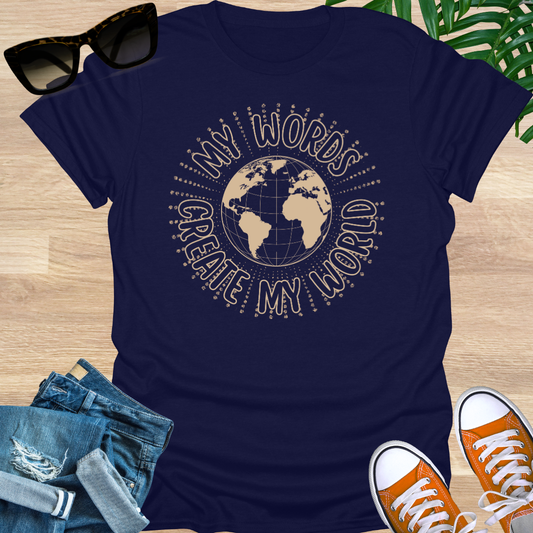 Beige world globe illustration with the phrase “My Words Create My World,” symbolizing manifestation, intention, and conscious creation on a navy unisex tee