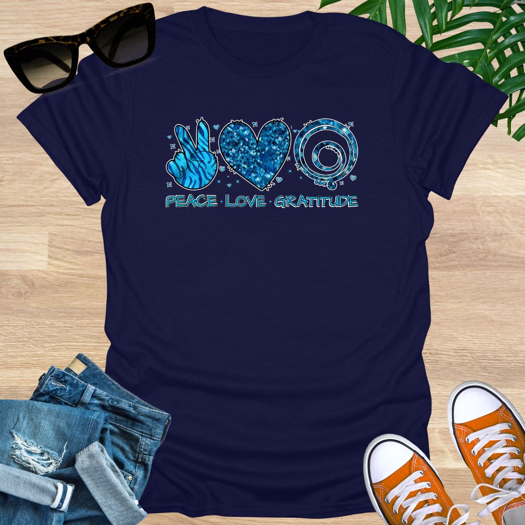 Navy unisex T-shirt with peace sign, heart, and spiral text reading “Peace • Love • Gratitude.”