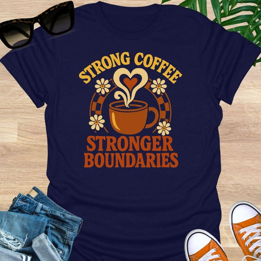 Navy blue unisex t-shirt. Retro coffee cup with heart-shaped steam and daisies over the words Strong Coffee Stronger Boundaries 