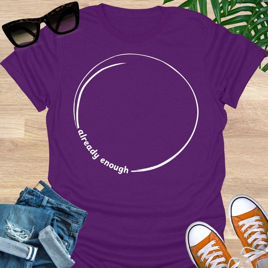 Minimal incomplete circle line art with the words “already enough” on a purple unisex t-shirt