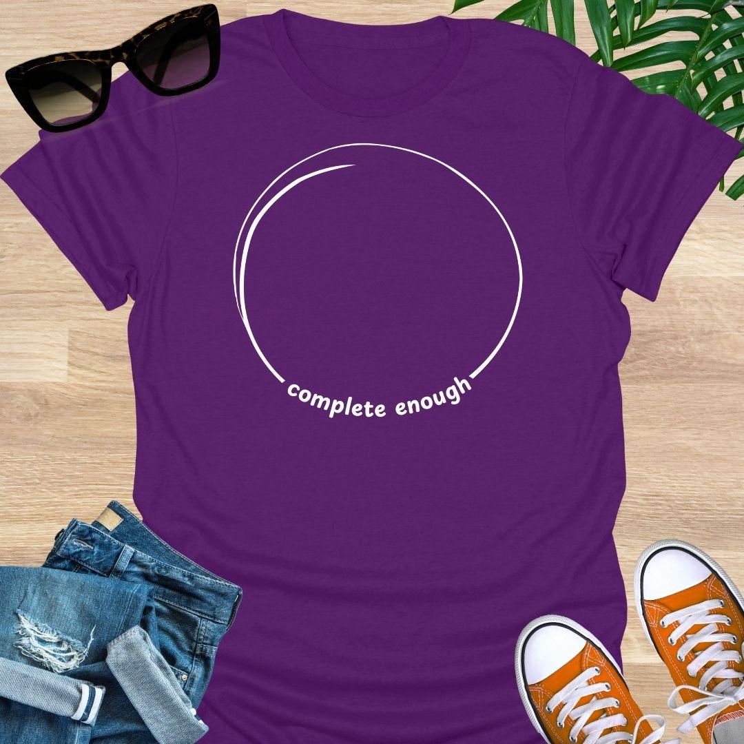 Minimal incomplete circle line art with the words “complete enough” on a purple unisex t-shirt