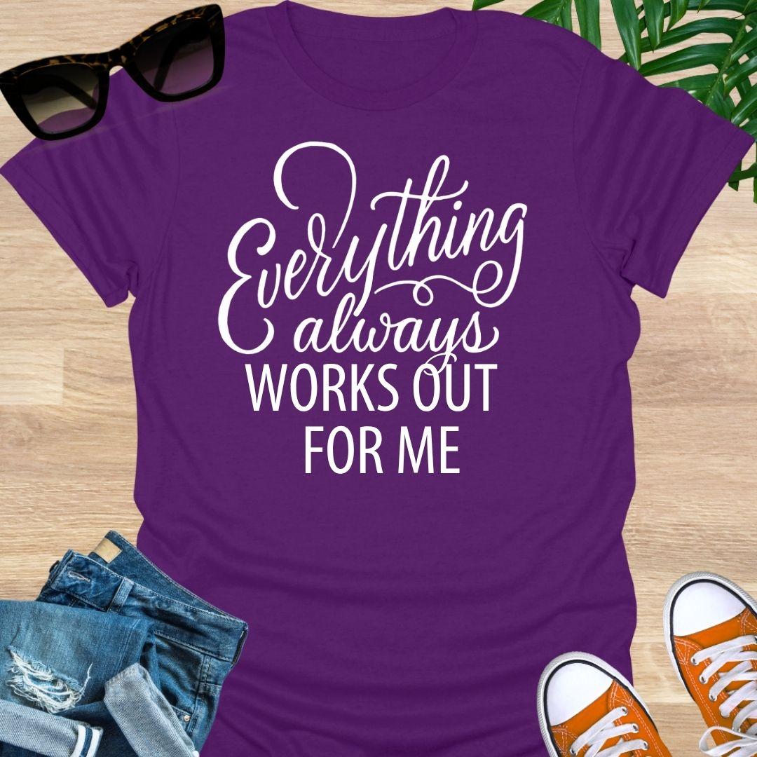 White script text reads “Everything always works out for me” on a purple unisex affirmation tee.