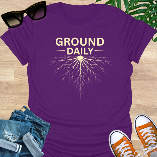 Minimal line art roots with the words “Ground Daily” on a purple unisex t-shirt