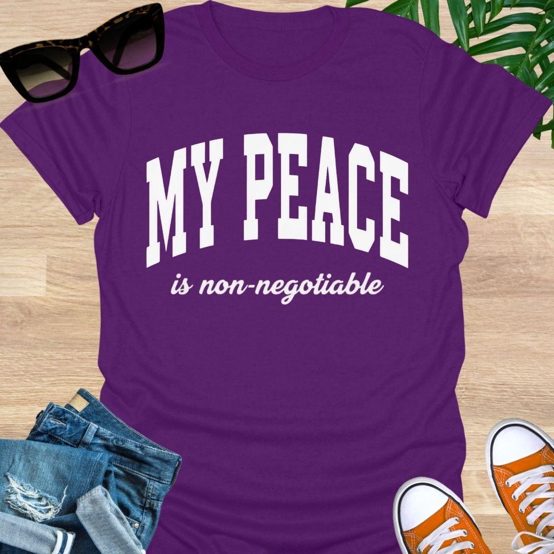 “My Peace Is Non-Negotiable” in white collegiate lettering on a purple unisex tee.