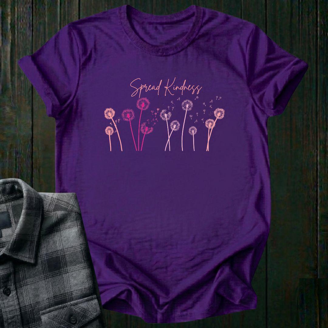 Purple t-shirt with 'Spread Kindness' design on a wooden surface with a plaid shirt.
