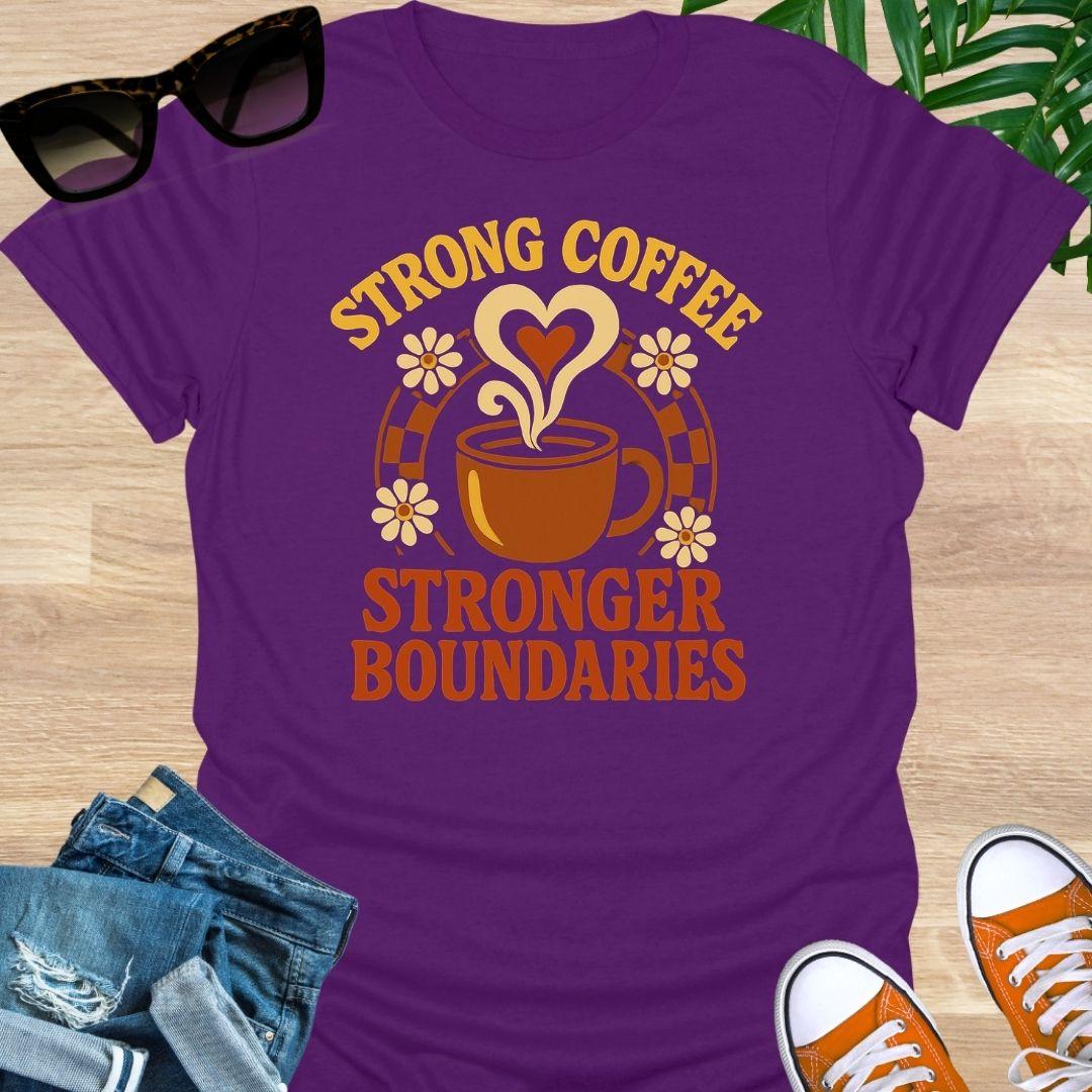 Purple unisex t-shirt. Retro coffee cup with heart-shaped steam and daisies over the words Strong Coffee Stronger Boundaries 