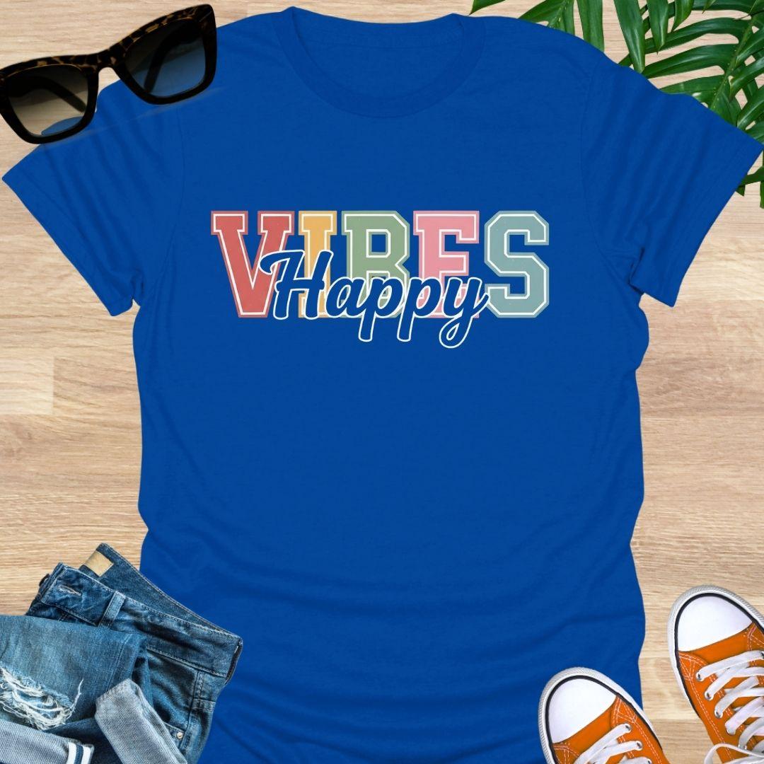 “Happy Vibes” in retro varsity letters with script overlay on a blue unisex tee.