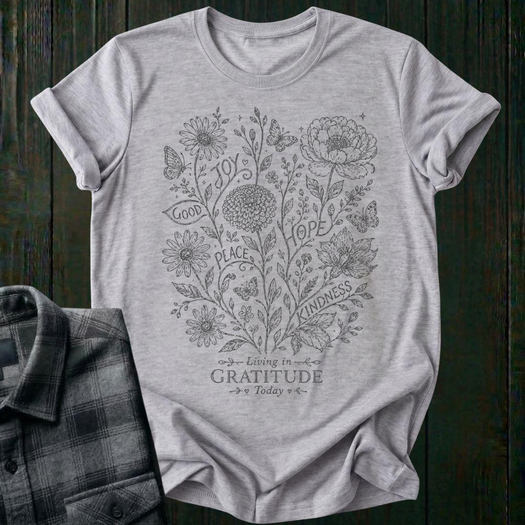 Vintage botanical illustration featuring flowers, butterflies, leaves, and the inspirational words joy, hope, peace, kindness, and good above the phrase Living in Gratitude Today on a sports gray shirt